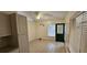 Eat-in dining area with a dark green door and white tile flooring at 11617 Duda Rd, Hudson, FL 34667