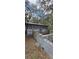 Outbuilding exterior shows metal siding and brick foundation with some new brick at 11617 Duda Rd, Hudson, FL 34667