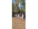 Outbuilding exterior shows metal siding and brick foundation with an open door at 11617 Duda Rd, Hudson, FL 34667