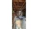 Outbuilding interior shows exposed wooden beams, a wooden door, and items littering the space at 11617 Duda Rd, Hudson, FL 34667