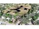 Scenic aerial view of a stilt home surrounded by trees, with marshland nearby at 12724 Circle Lake Dr, Hudson, FL 34669
