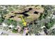 Scenic aerial view of a stilt home surrounded by trees, with marshland nearby, marked with an arrow at 12724 Circle Lake Dr, Hudson, FL 34669