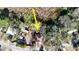 An aerial view of a single-Gathering house, surrounded by trees, is enhanced with an arrow at 12724 Circle Lake Dr, Hudson, FL 34669