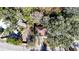 Aerial view of a home surrounded by lush trees, a long driveway, and a nearby road at 12724 Circle Lake Dr, Hudson, FL 34669
