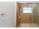 Tiled shower stall features glass doors and a mounted shower head at 12724 Circle Lake Dr, Hudson, FL 34669