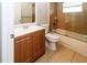 Bathroom featuring a vanity with storage, a toilet, and a shower/tub combo with tiled surround at 12724 Circle Lake Dr, Hudson, FL 34669