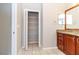 Bathroom with wooden cabinets, granite countertop, and a linen closet at 12724 Circle Lake Dr, Hudson, FL 34669