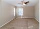 Bright empty room featuring hardwood floors and two windows at 12724 Circle Lake Dr, Hudson, FL 34669