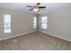 Bright bedroom with neutral walls, carpet flooring, and natural light from three windows at 12724 Circle Lake Dr, Hudson, FL 34669