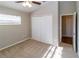 Neutral bedroom with a ceiling fan, closet, and window provides a cozy atmosphere at 12724 Circle Lake Dr, Hudson, FL 34669