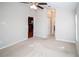 Bright bedroom featuring neutral walls and carpet and open doorway to kitchen at 12724 Circle Lake Dr, Hudson, FL 34669