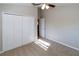 Bedroom with neutral walls, carpeted floor, ceiling fan, closet with folding doors, and open doorway at 12724 Circle Lake Dr, Hudson, FL 34669