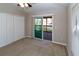 Bedroom with neutral walls, carpeted floor, ceiling fan, a sliding glass door, and a large closet at 12724 Circle Lake Dr, Hudson, FL 34669
