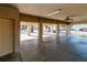 Large concrete carport on stilted home featuring ceiling fans, support beams, and lots of space at 12724 Circle Lake Dr, Hudson, FL 34669