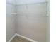 Walk-in closet with multiple shelves for storage, and neutral carpet at 12724 Circle Lake Dr, Hudson, FL 34669