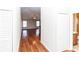 Inviting hallway with wood floors that leads to a bathroom and living area with natural light at 12724 Circle Lake Dr, Hudson, FL 34669