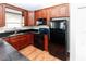 A kitchen featuring black appliances, granite countertops, and dark wood cabinets at 12724 Circle Lake Dr, Hudson, FL 34669