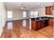 Living room features hardwood floors, lots of windows and connects to the kitchen at 12724 Circle Lake Dr, Hudson, FL 34669