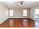 Large living room with hardwood floors and lots of natural light. Has access to a porch at 12724 Circle Lake Dr, Hudson, FL 34669