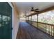Spacious wood patio with ceiling fans and views of lush greenery at 12724 Circle Lake Dr, Hudson, FL 34669
