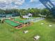 Scenic view showcasing bocce ball and shuffleboard courts with covered seating and trees at 1322 Hickory Moss Pl, Trinity, FL 34655