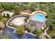 A beautiful aerial view of the community pool, water park, playground, volleyball court, and clubhouse at 13304 Mandalay Pl, Spring Hill, FL 34609