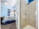 Bathroom featuring a walk-in shower, glass enclosure, and seamless connection to the main bedroom at 13304 Mandalay Pl, Spring Hill, FL 34609