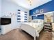 Nautical themed bedroom featuring a queen bed, TV, shelves, and 'NBG' wall decor at 13304 Mandalay Pl, Spring Hill, FL 34609