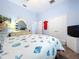 Bright bedroom featuring a white bed with sea-themed bedding, light blue walls and white trim at 13304 Mandalay Pl, Spring Hill, FL 34609