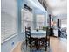 Charming breakfast nook features a blue tablecloth, windows, and seating for four guests at 13304 Mandalay Pl, Spring Hill, FL 34609