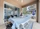 Covered patio featuring a white picnic table with blue checkered tablecloth, ideal for outdoor dining at 13304 Mandalay Pl, Spring Hill, FL 34609