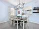 Bright dining room boasts modern lighting fixture, table set for eight, and light blue walls at 13304 Mandalay Pl, Spring Hill, FL 34609