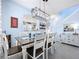 Open concept dining area with modern chandelier and view of staircase, adjacent to a kitchen at 13304 Mandalay Pl, Spring Hill, FL 34609