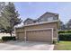Two story home featuring an attached two car garage, neutral color scheme, and manicured landscaping at 13304 Mandalay Pl, Spring Hill, FL 34609