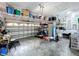 Spacious garage featuring ample storage, shelving, work bench, and white door at 13304 Mandalay Pl, Spring Hill, FL 34609