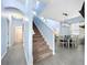 Inviting hallway leading to a dining area and staircase, with consistent flooring throughout at 13304 Mandalay Pl, Spring Hill, FL 34609