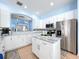 Gourmet kitchen featuring marble island, stainless steel appliances, and lots of storage in white cabinets at 13304 Mandalay Pl, Spring Hill, FL 34609