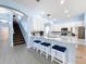 Stylish kitchen with marble countertops, white cabinets, island with seating, and modern appliances at 13304 Mandalay Pl, Spring Hill, FL 34609
