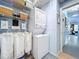 Well-organized laundry room with a stackable washer and dryer, shelving, and storage baskets at 13304 Mandalay Pl, Spring Hill, FL 34609