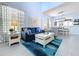 Comfortable living room with a cozy blue couch and views to dining area at 13304 Mandalay Pl, Spring Hill, FL 34609