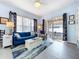 Comfortable living room featuring large windows, stylish decor, and access to an outdoor patio at 13304 Mandalay Pl, Spring Hill, FL 34609