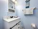 Nautical themed powder room with shiplap vanity and 'Beach Rules' decor at 13304 Mandalay Pl, Spring Hill, FL 34609