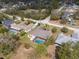 Aerial view of a home with a screened-in pool in a lush, green neighborhood at 1382 Aladdin Rd, Spring Hill, FL 34609