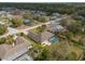 Overhead shot of home with screened pool, surrounded by a verdant residential neighborhood at 1382 Aladdin Rd, Spring Hill, FL 34609