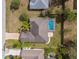 Aerial view of the property featuring a pool and a well-manicured lawn at 1382 Aladdin Rd, Spring Hill, FL 34609