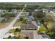 Aerial view of home with private pool, lovely landscaping, and surrounding community at 1382 Aladdin Rd, Spring Hill, FL 34609