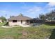 Spacious backyard with a screened-in pool, patio area, and lush green lawn at 1382 Aladdin Rd, Spring Hill, FL 34609