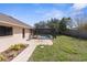 Well-maintained backyard featuring a screened pool area, patio, and manicured lawn at 1382 Aladdin Rd, Spring Hill, FL 34609
