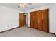 Bedroom with tile flooring, ceiling fan and wooden closet doors at 1382 Aladdin Rd, Spring Hill, FL 34609