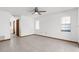 Clean bedroom with neutral walls, tile flooring, two windows with blinds, ceiling fan, and closet at 1382 Aladdin Rd, Spring Hill, FL 34609